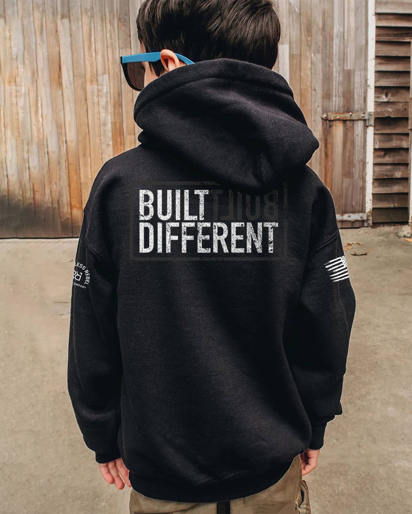 Boy Wearing Solid Black Youth Built Different Back Design Hoodie