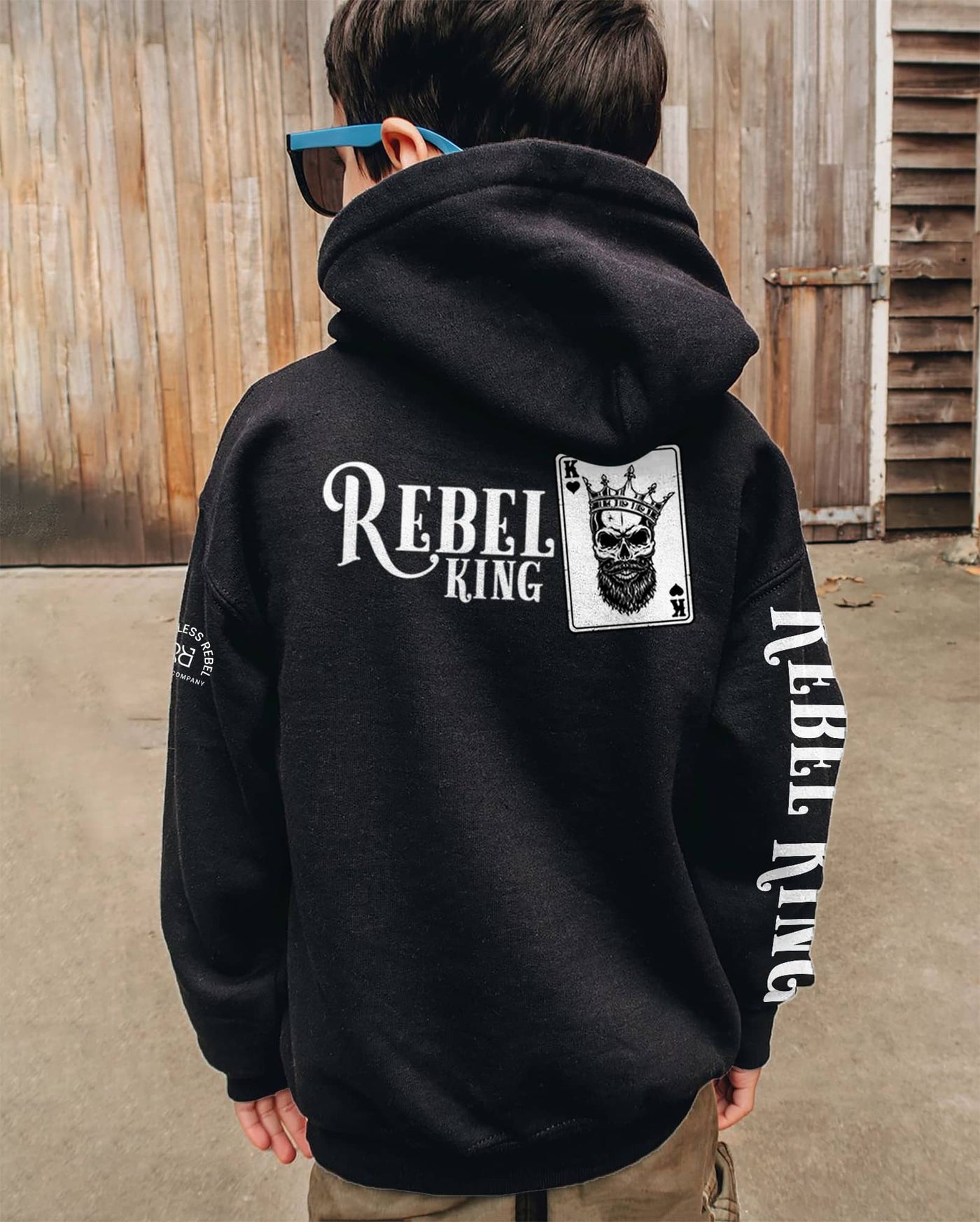 Boy wearing Solid Black Youth Rebel King Sleeve and Back Design Hoodie