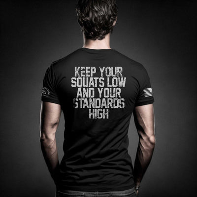 Man wearing Solid Black Men's Keep Your Squats Low and Your Standards High Back Design Tee