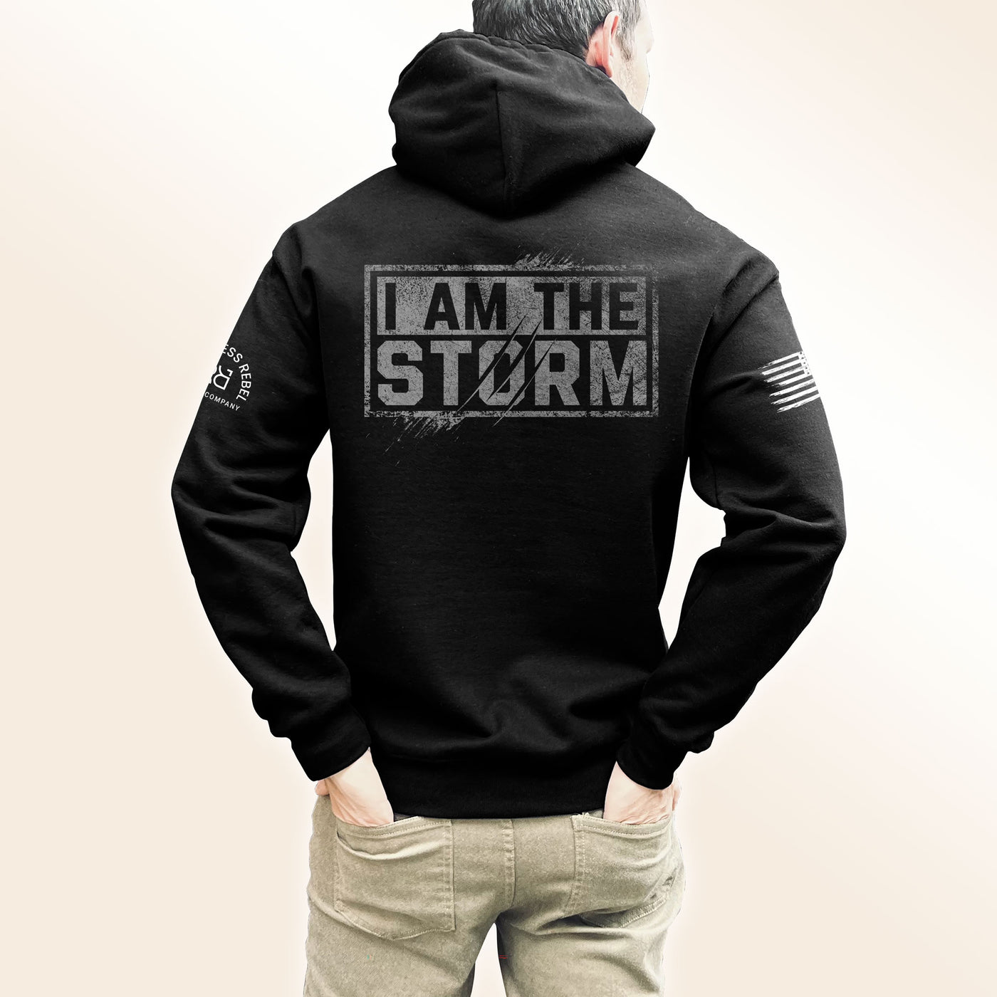 Man wearing Solid Black Men's I Am The Storm Back Design Hoodie