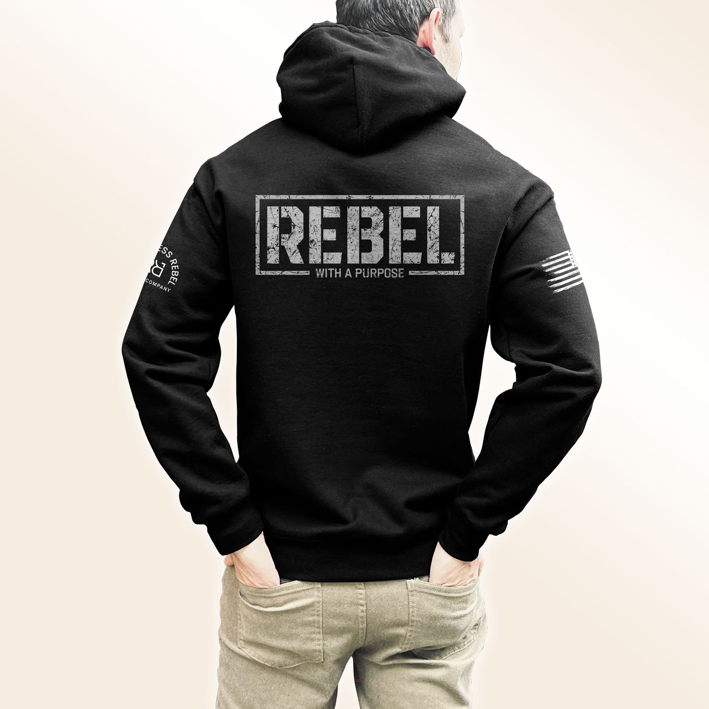 Man wearing Solid Black Men's Rebel With A Purpose Back Design Hoodie
