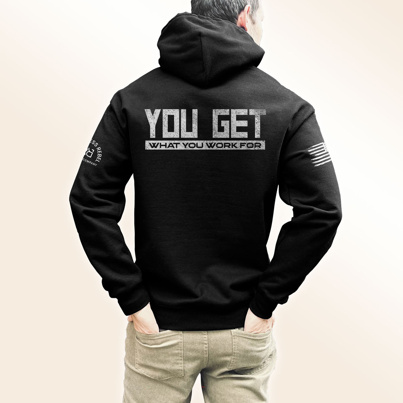 Man wearing Solid Black Men's You Get What You Work For Back Design Hoodie