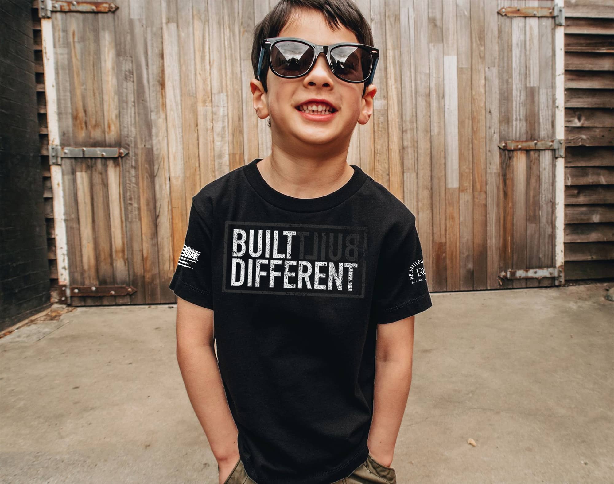 Boy wearing a Built Different youth t-shirt