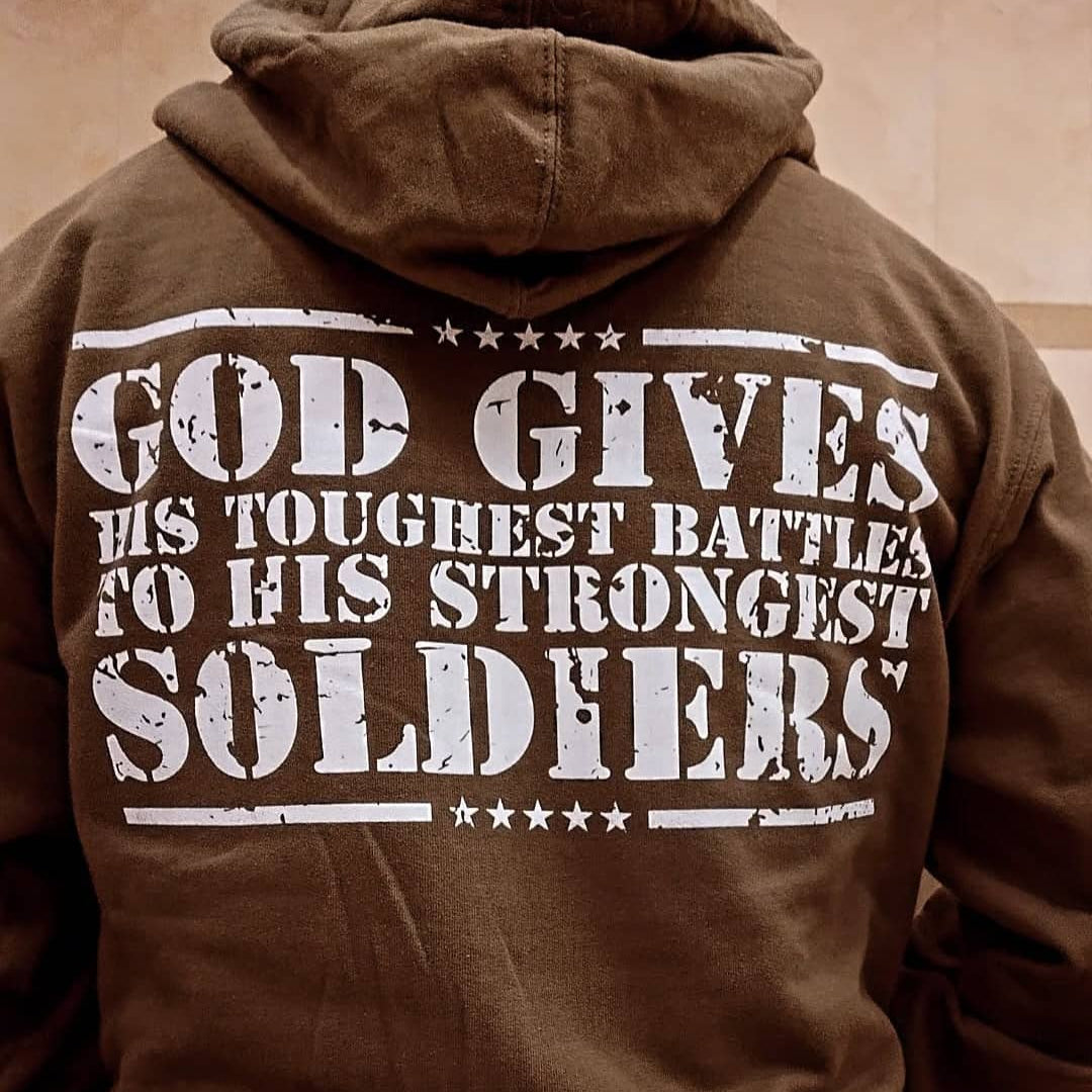 Brown hoodie with motivational text on the back worn by a person.
