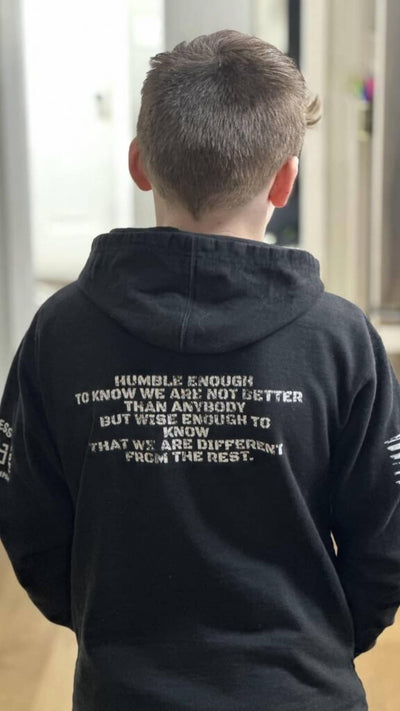 Boy wearing Solid Black Youth Humble Enough Back Design Hoodie