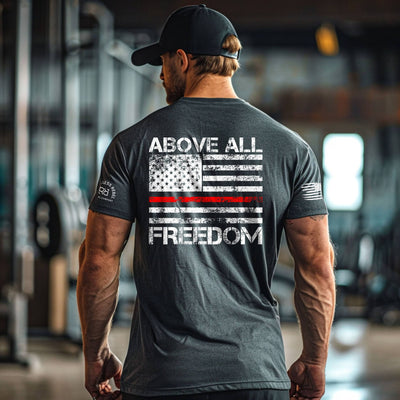 Man wearing a t-shirt with 'Above All Freedom' design in a gym setting
