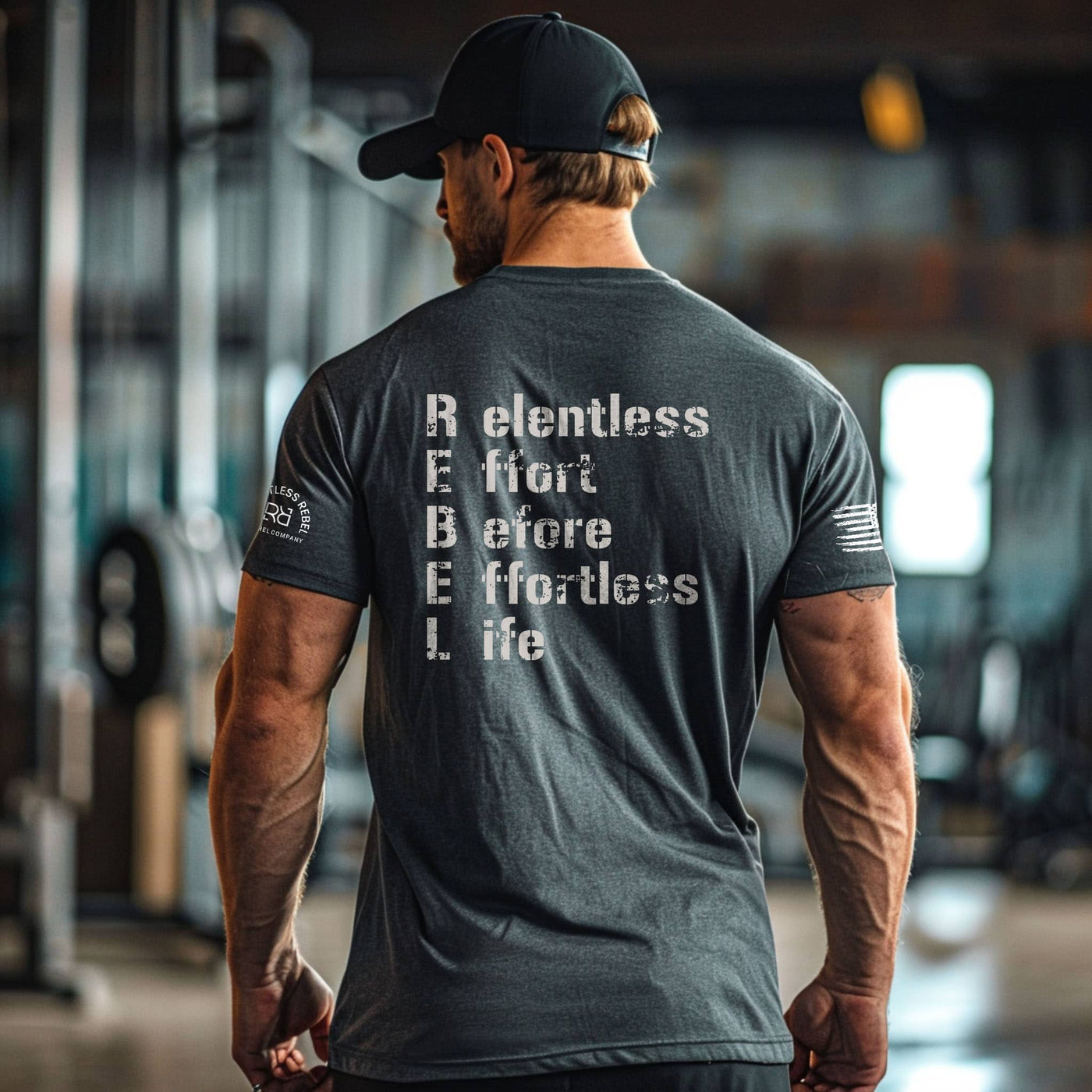 Man wearing a t-shirt with motivational text in a gym setting