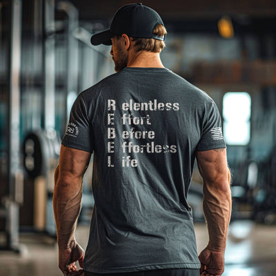 Man wearing a t-shirt with motivational text in a gym setting