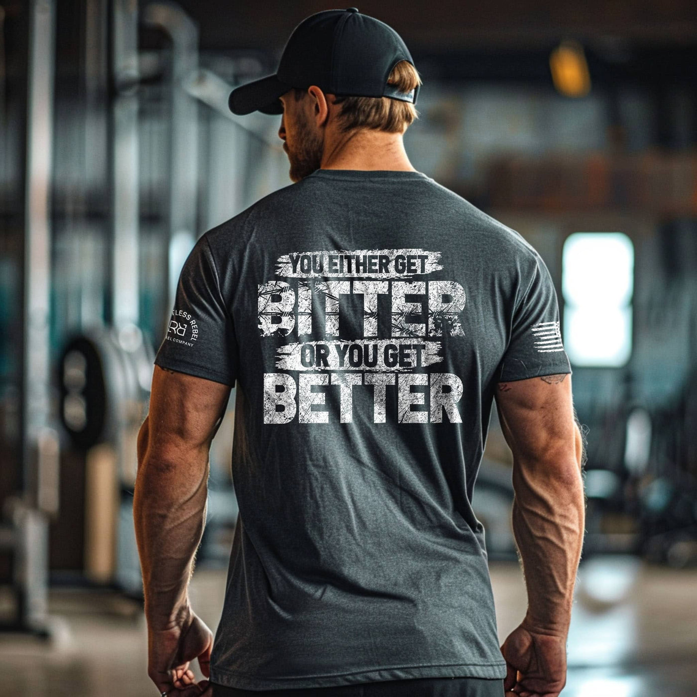 Man wearing a t-shirt with motivational text in a gym setting