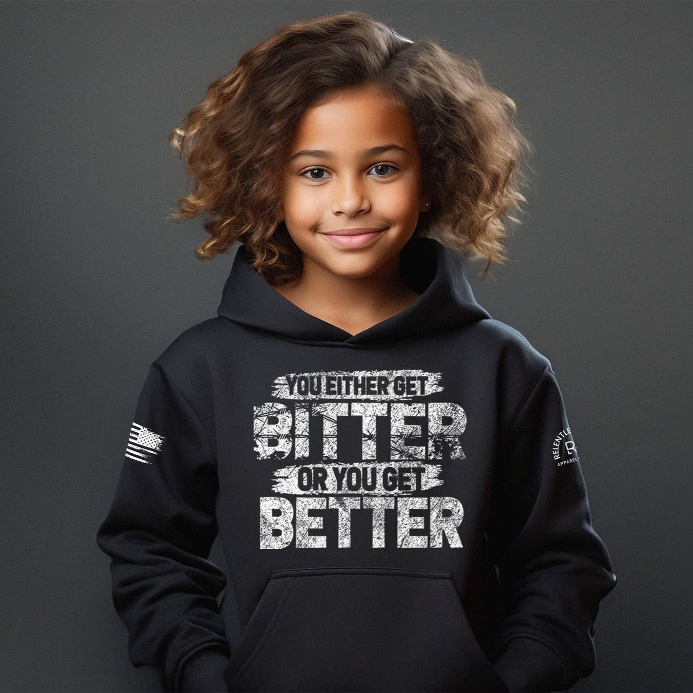 Child wearing a black hoodie with motivational text on a dark background