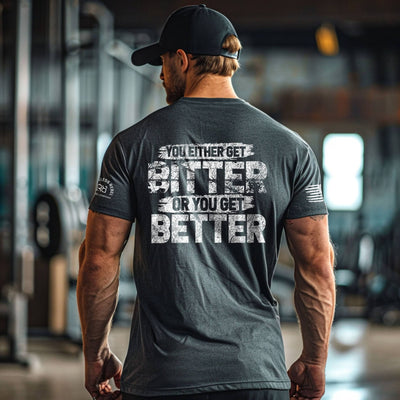 Man wearing a t-shirt with motivational text in a gym setting
