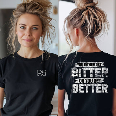 Person wearing a black t-shirt with a logo on the front and motivational quote on the back.