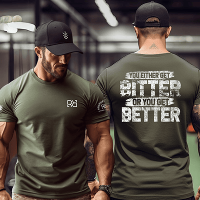 Two men wearing green t-shirts, one with a brand logo on the front and the other with motivational text on the back.