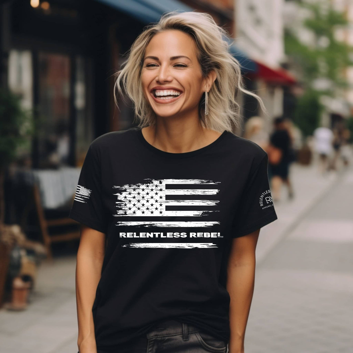 Woman wearing a black t-shirt with an American flag design and 'Relentless Rebel' text on a city street.
