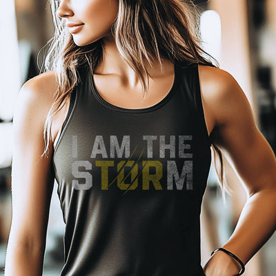Person wearing a black tank top with 'I AM THE STORM' text in a gym setting