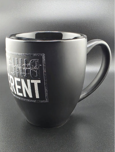 Black mug with white text on a gray background
