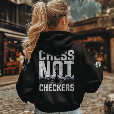 Person wearing a black hoodie with 'Chess Not Checkers' text and graphic on the back.