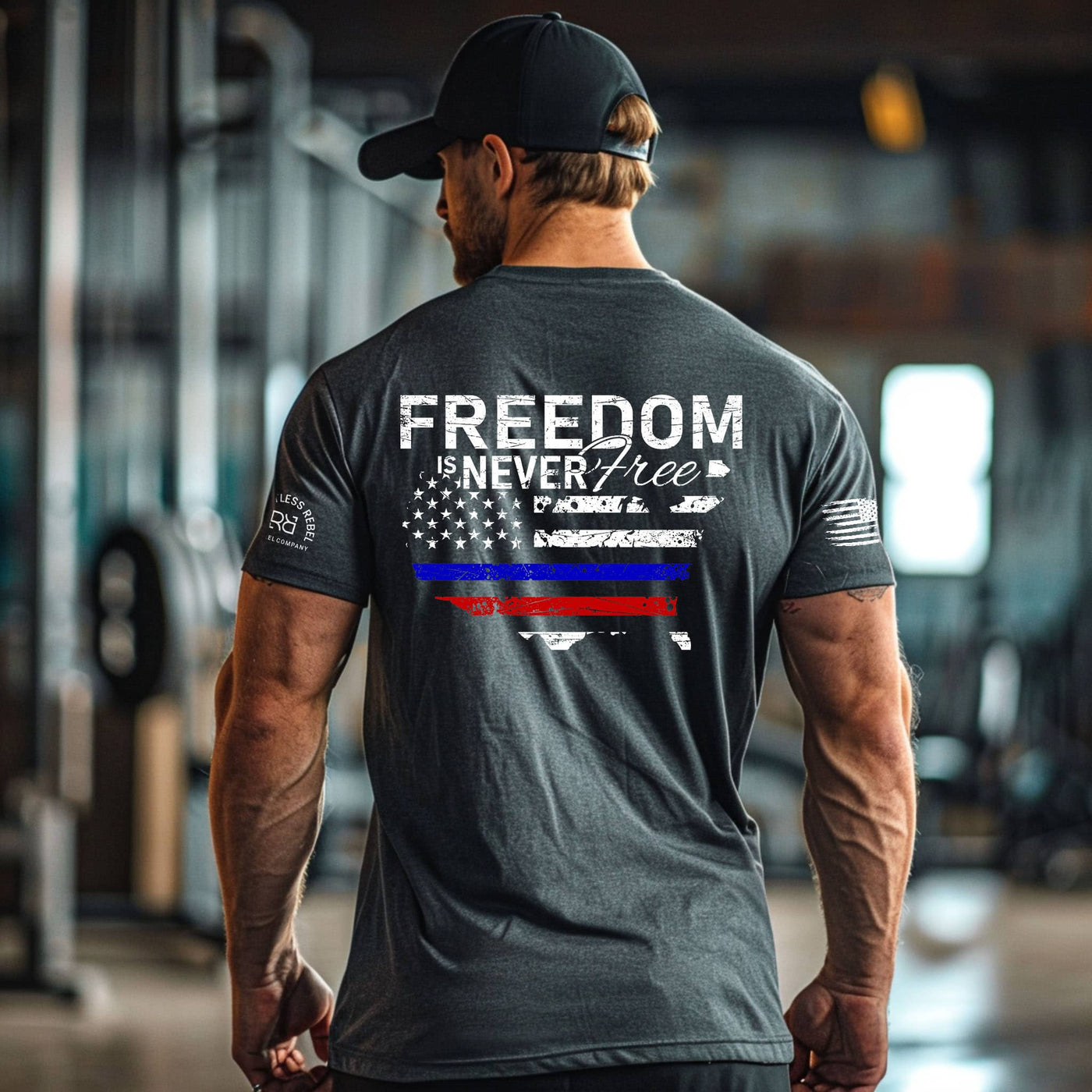 Man wearing a t-shirt with 'Freedom is Never Free' design in an indoor setting