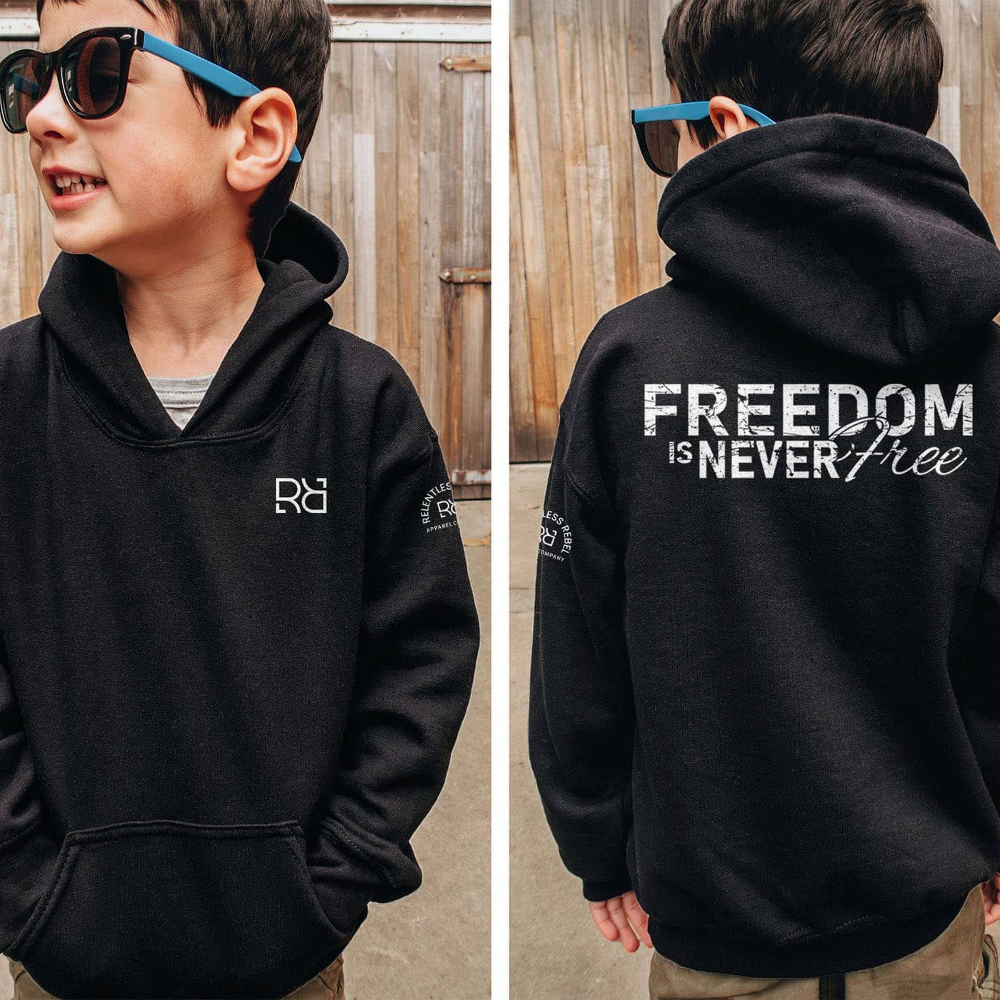 Child wearing a black hoodie with 'Freedom is Never Free' text on the back, standing in front of a wooden fence.