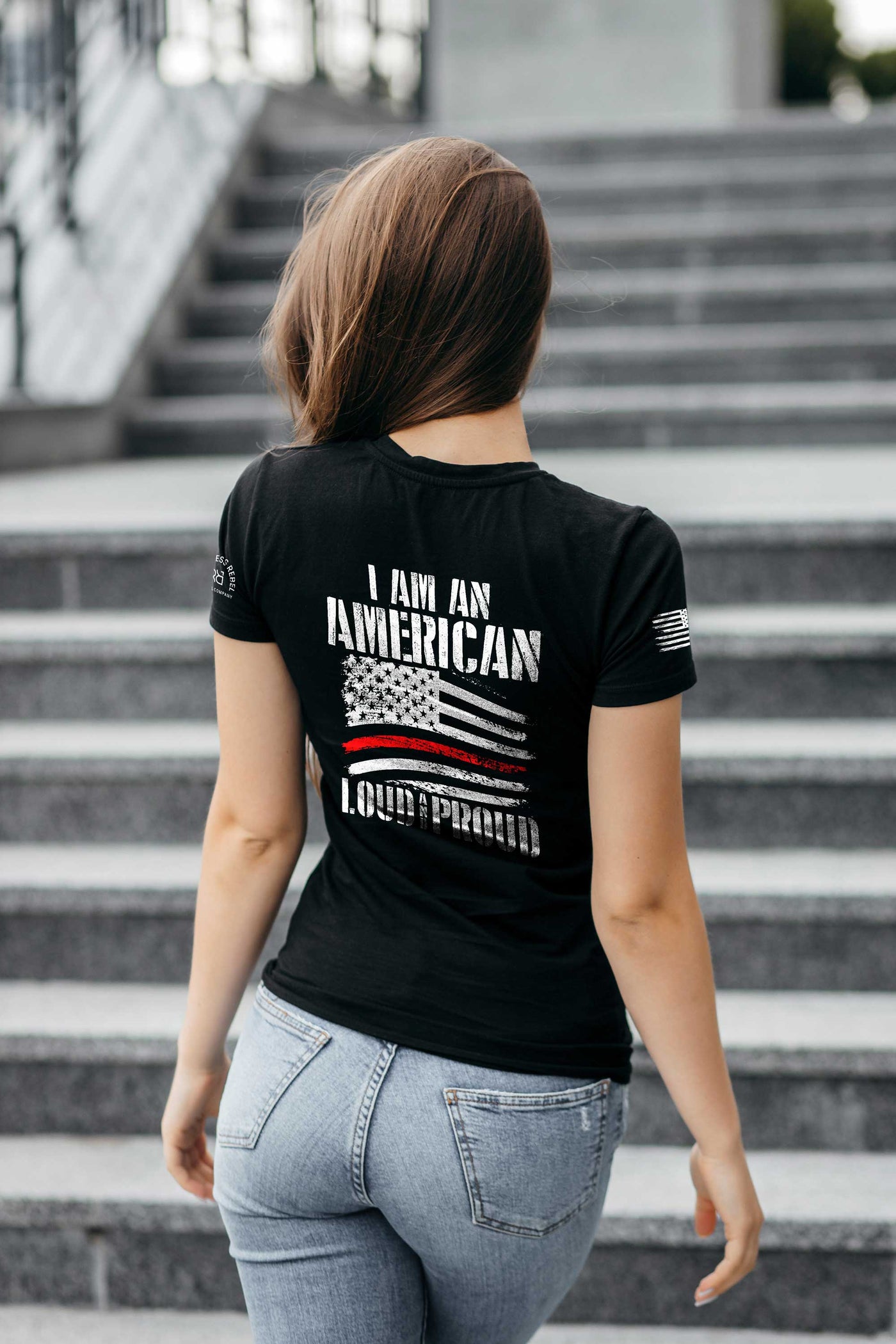 Woman wearing Solid Black Women's I Am An American Loud and Proud Back Design Tee