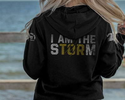 Woman wearing Solid Black Women's I Am The Storm  Back Design Hoodie