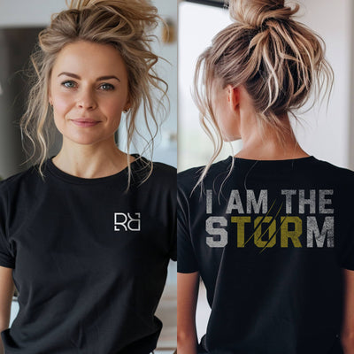 Person wearing a black t-shirt with a logo on the front and text on the back.