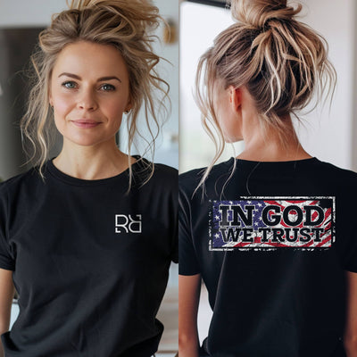 Person wearing a black t-shirt with 'In God We Trust' design on the back.