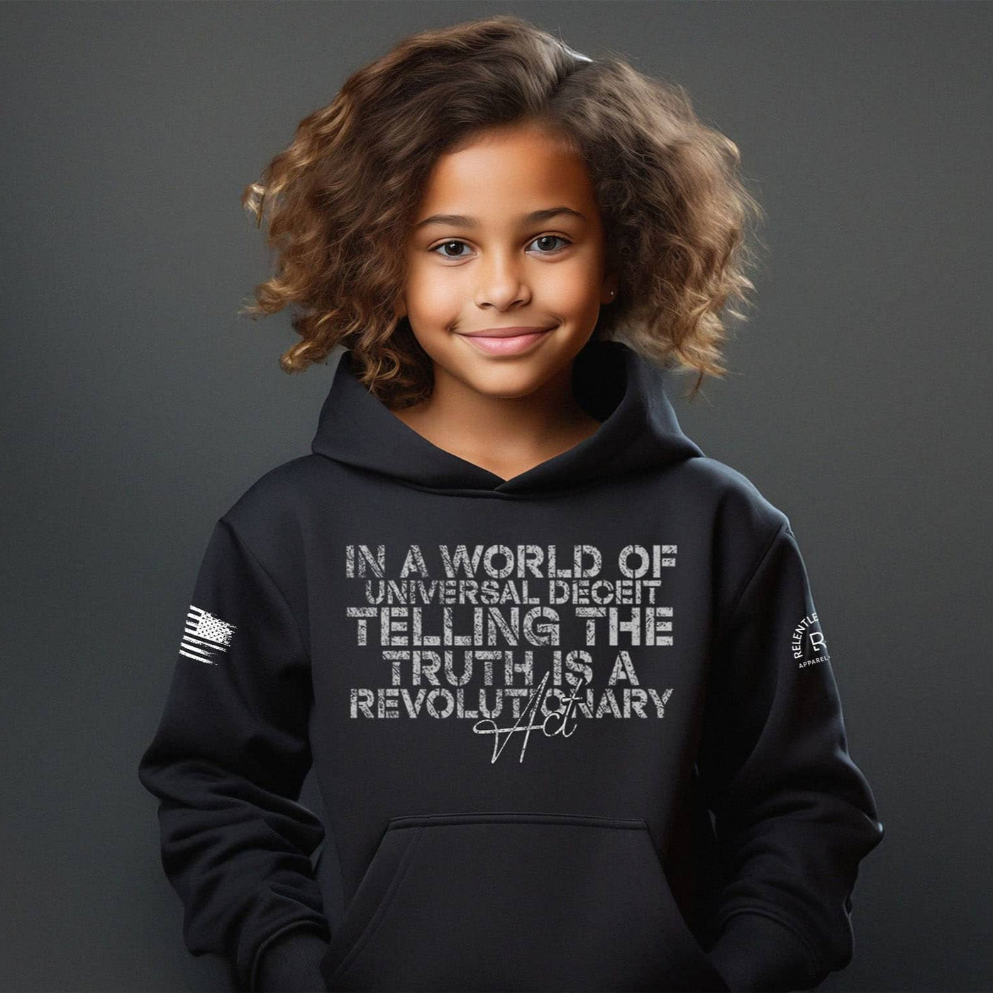 Child wearing a black hoodie with text on a dark background