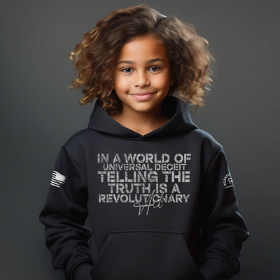 Child wearing a black hoodie with text on a dark background