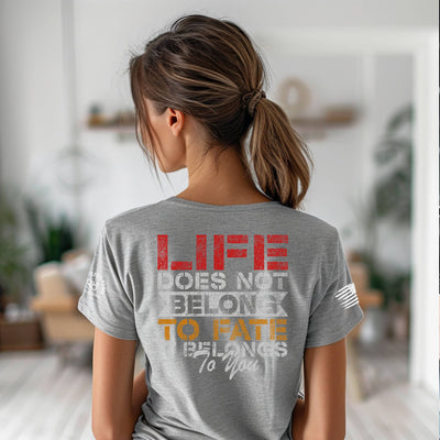 Person wearing a gray t-shirt with motivational quote in a home setting
