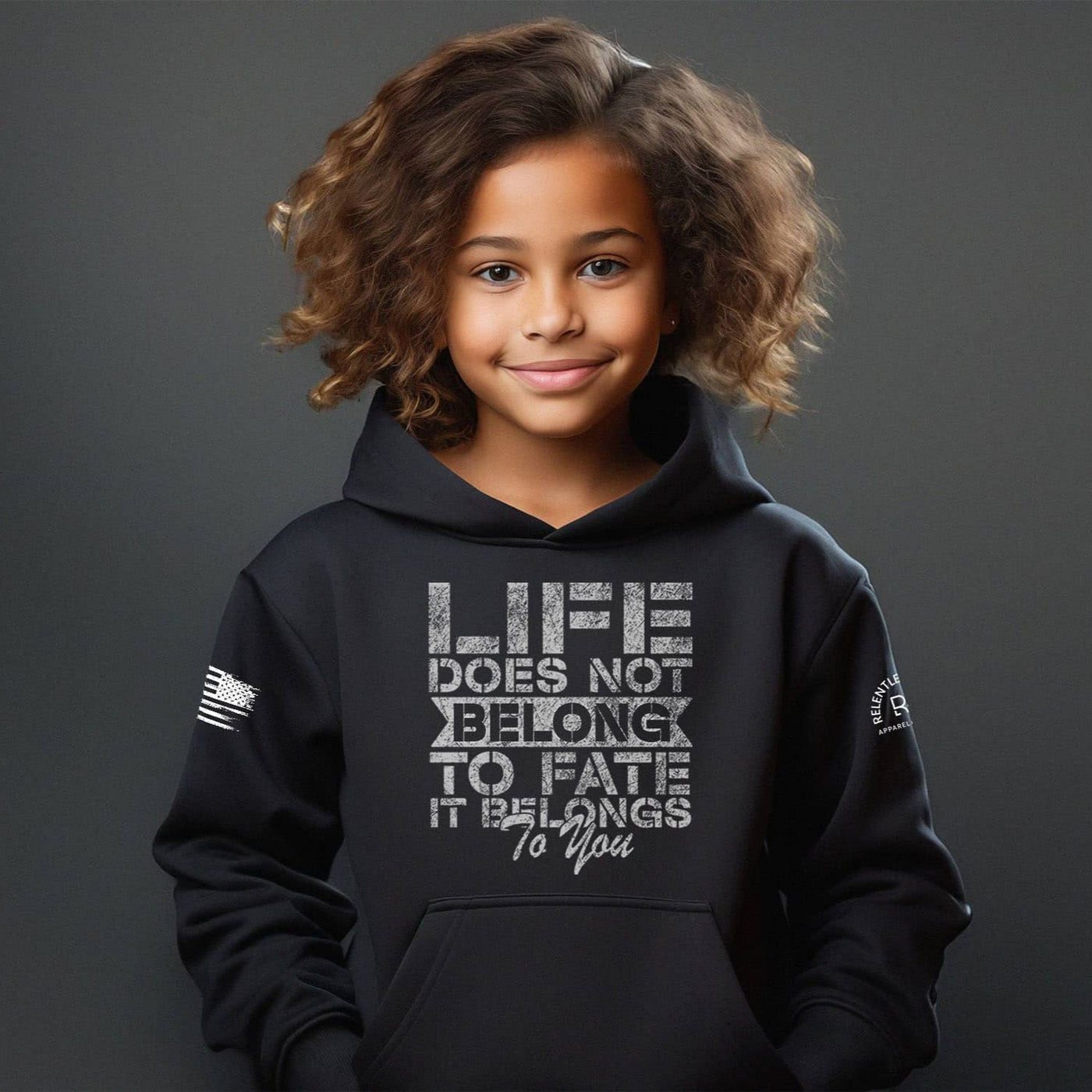 Child wearing a black hoodie with a motivational quote on a dark background
