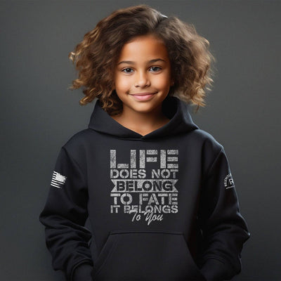 Child wearing a black hoodie with a motivational quote on a dark background