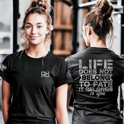 Two people wearing black t-shirts with visible branding and motivational quote.