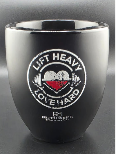 Black and silver tumbler with 'Lift Heavy Love Hard' design on a gray background