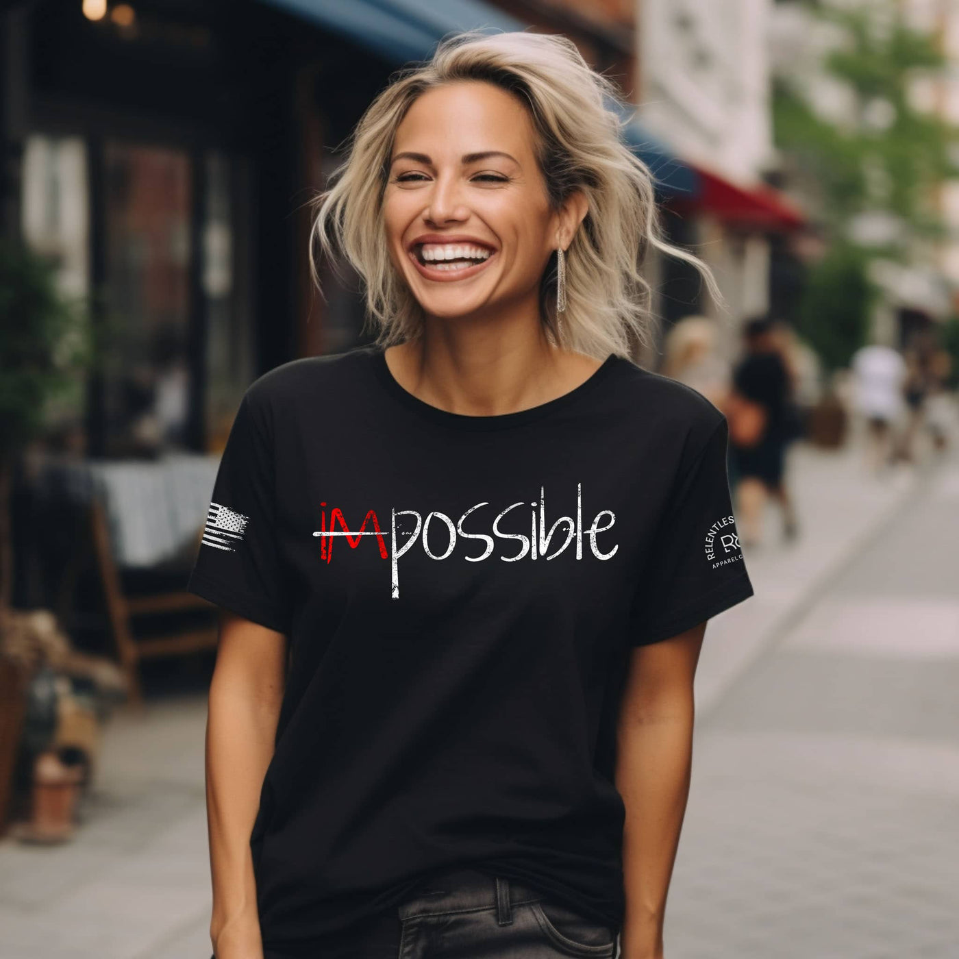 Woman wearing a black t-shirt with 'Impossible' text on a city street