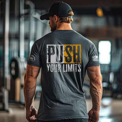 Man wearing a t-shirt with 'Push Your Limits' text in an indoor setting