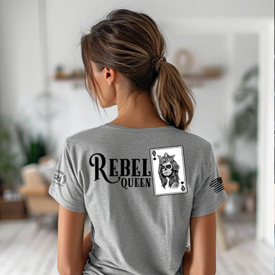 Person wearing a gray t-shirt with 'Rebel Queen' design on the back