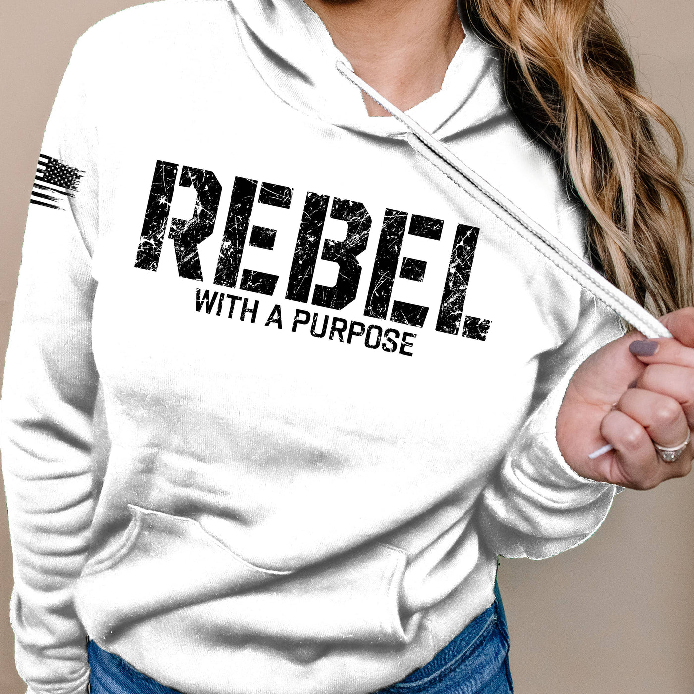 White hoodie with 'REBEL WITH A PURPOSE' text on a beige background
