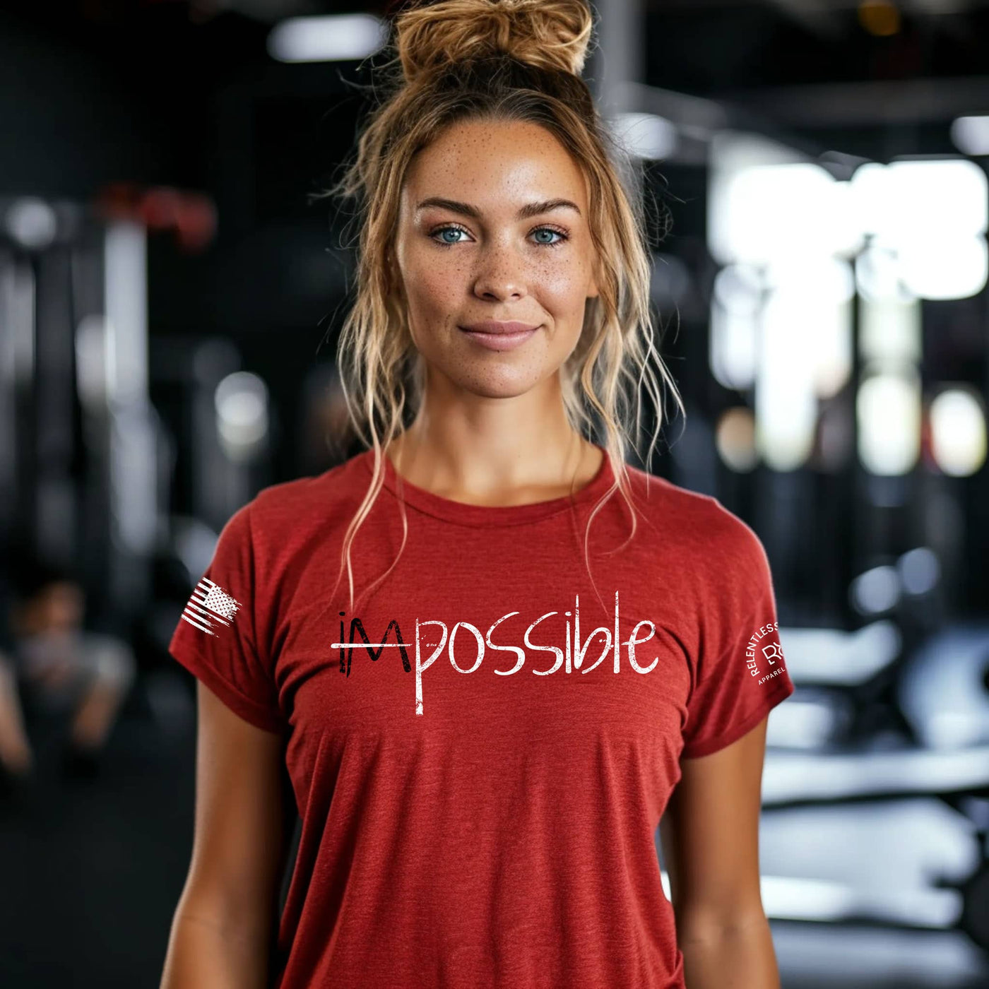 Woman wearing a red 'impossible' t-shirt in a gym setting