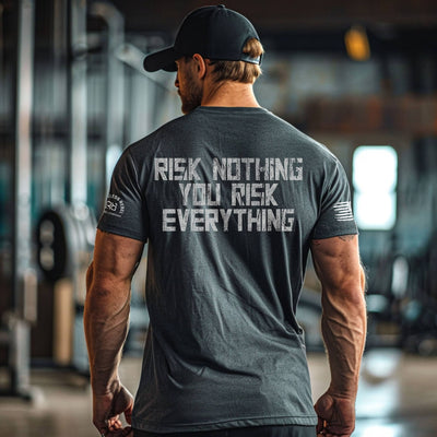 Man wearing a gray t-shirt with motivational text in a gym setting