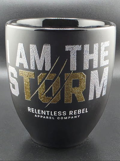Black tumbler with 'I am the Storm' text and Relentless Rebel logo on a dark background