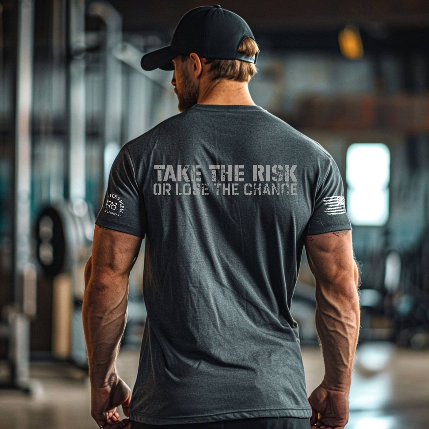 Man wearing a gray t-shirt with motivational text in a gym setting
