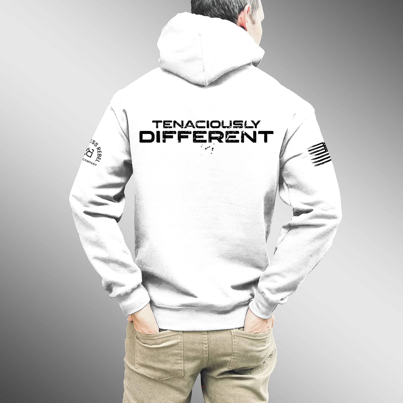 Person wearing a white hoodie with 'Tenaciously Different' text on the back against a gray background