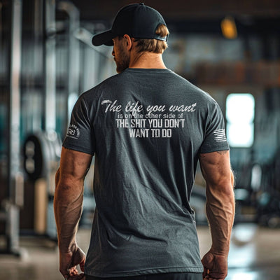 Man wearing a motivational t-shirt with text in a gym setting