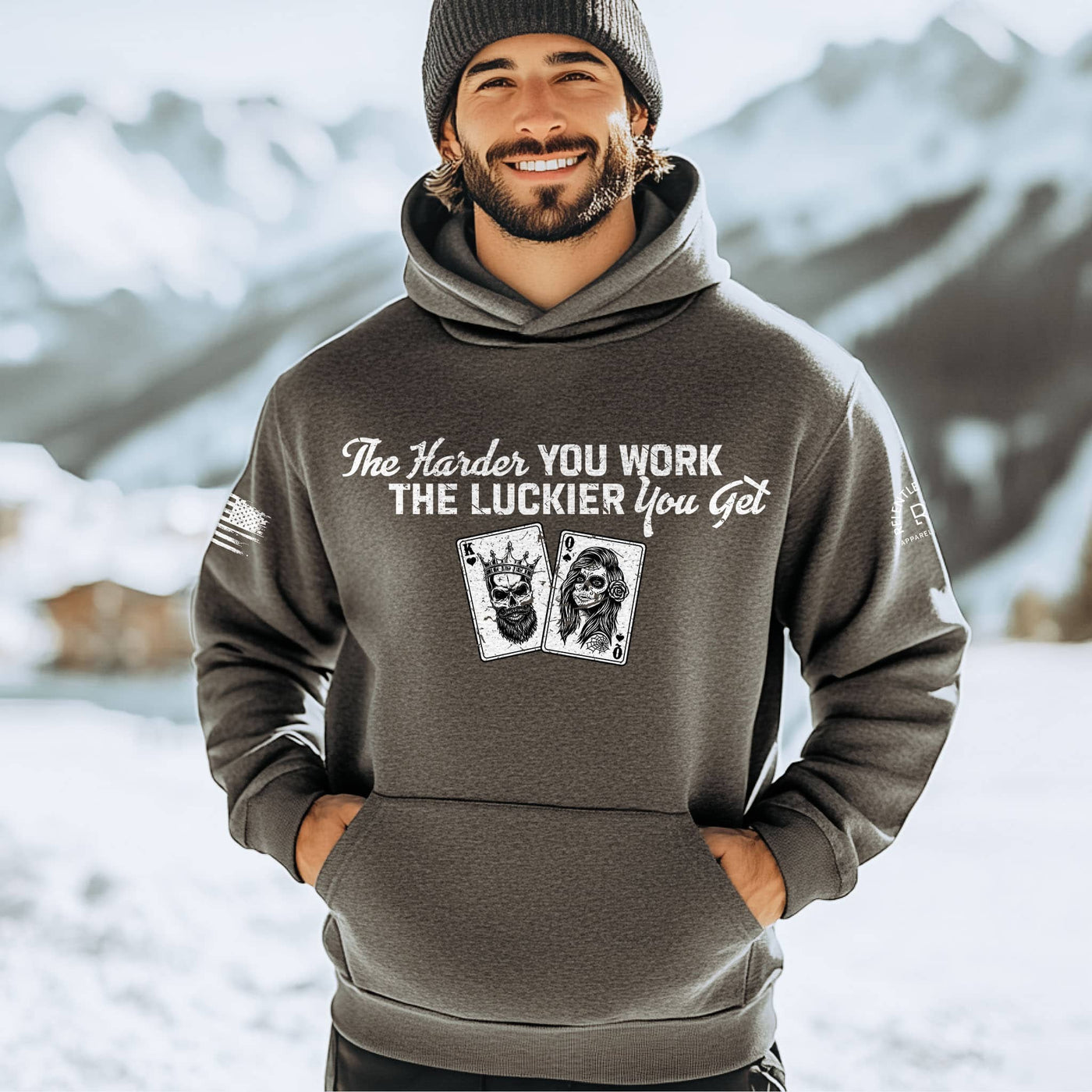 Man wearing a hoodie with motivational text and card design in a snowy landscape
