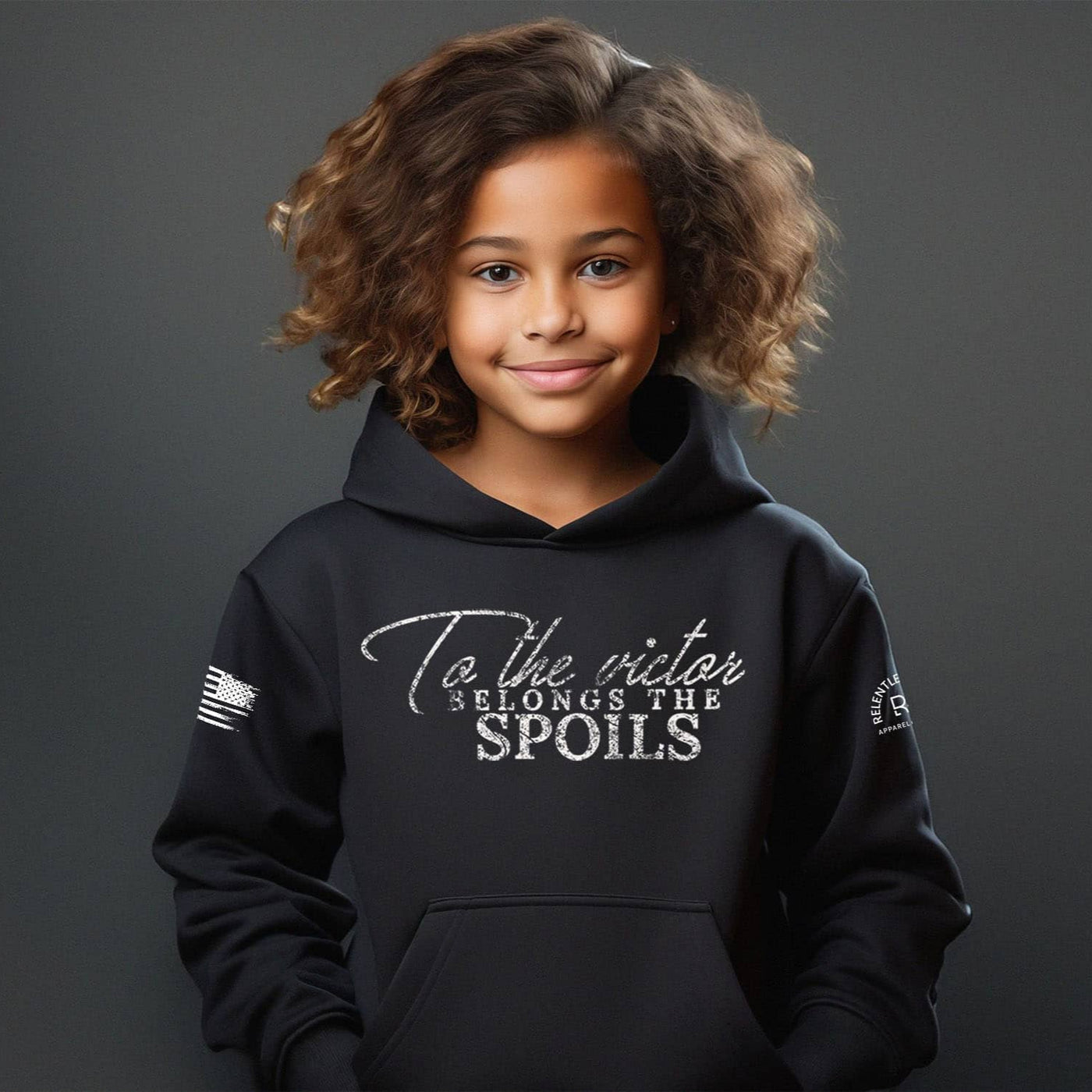 Child wearing a black hoodie with text on a dark background