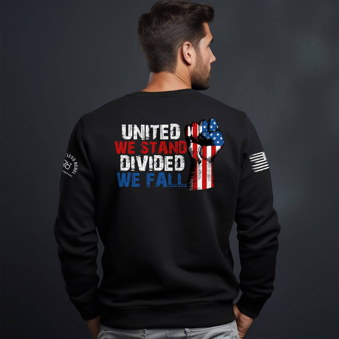 Black sweatshirt with text and graphic on the back, worn by a person against a dark background