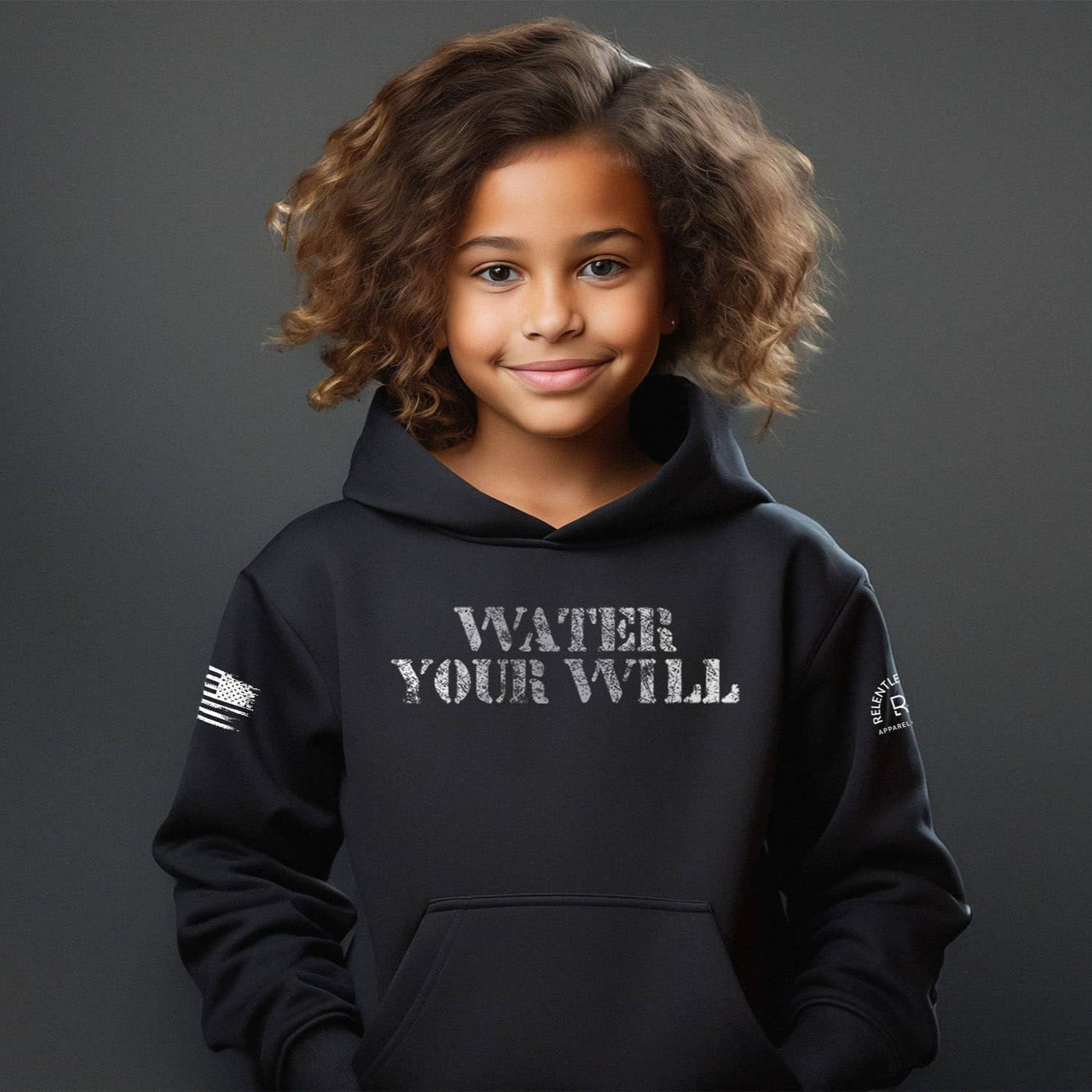 Child wearing a black hoodie with 'Water Your Will' text on a dark background