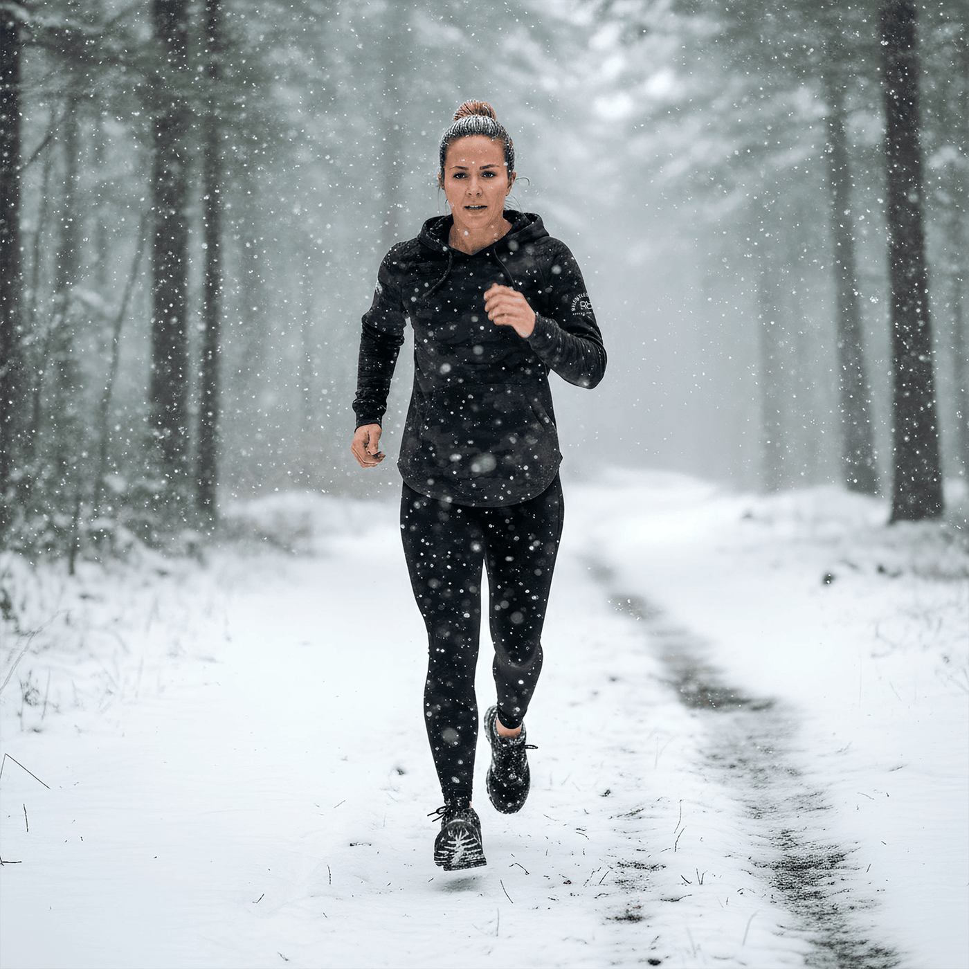 Person running in a snowy forest