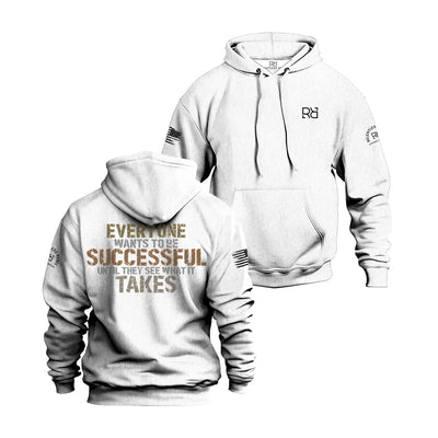 White hoodie with motivational quote on front and logo on sleeve against a white background